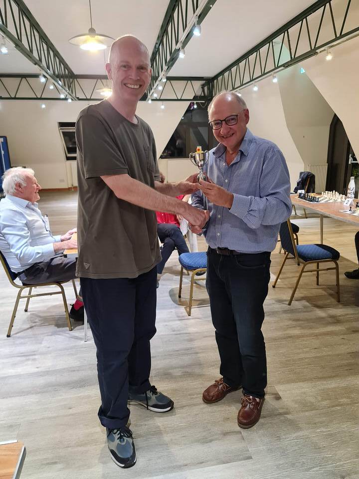 Gary Senior being presented with the trophy by Mark